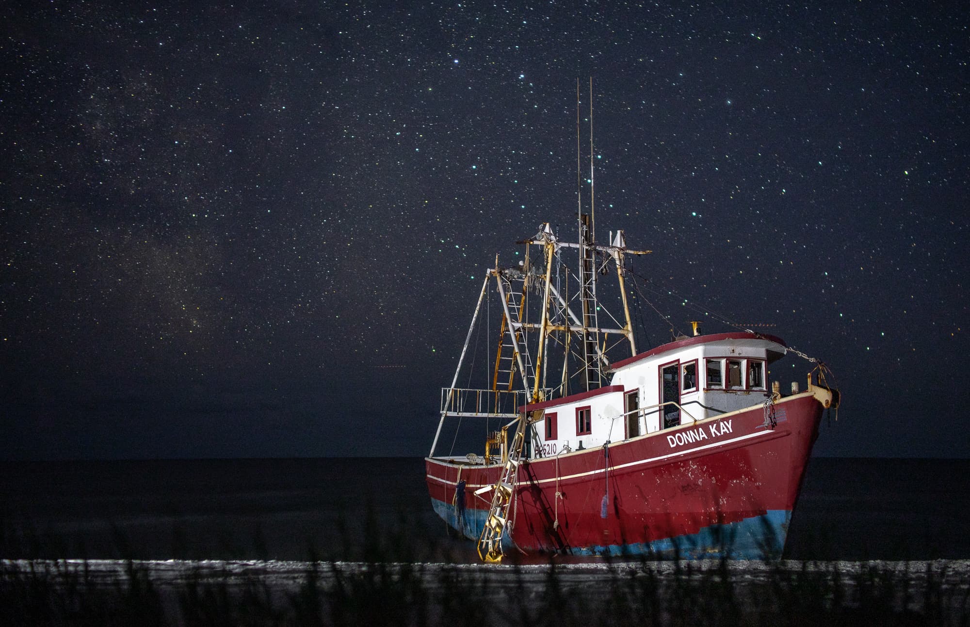 The shipwrecked Donna Kay beneath the Milky Way