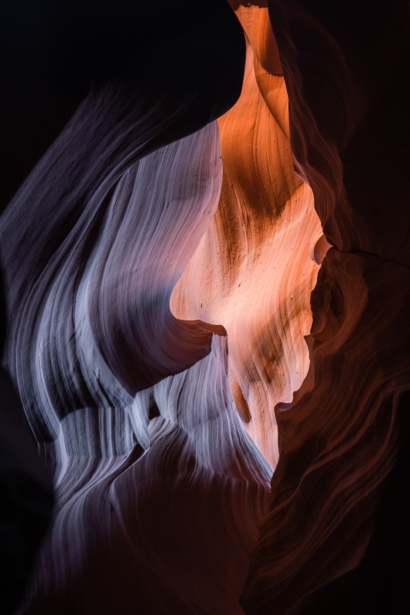 Layered canyon walls turning from shadow into warm light