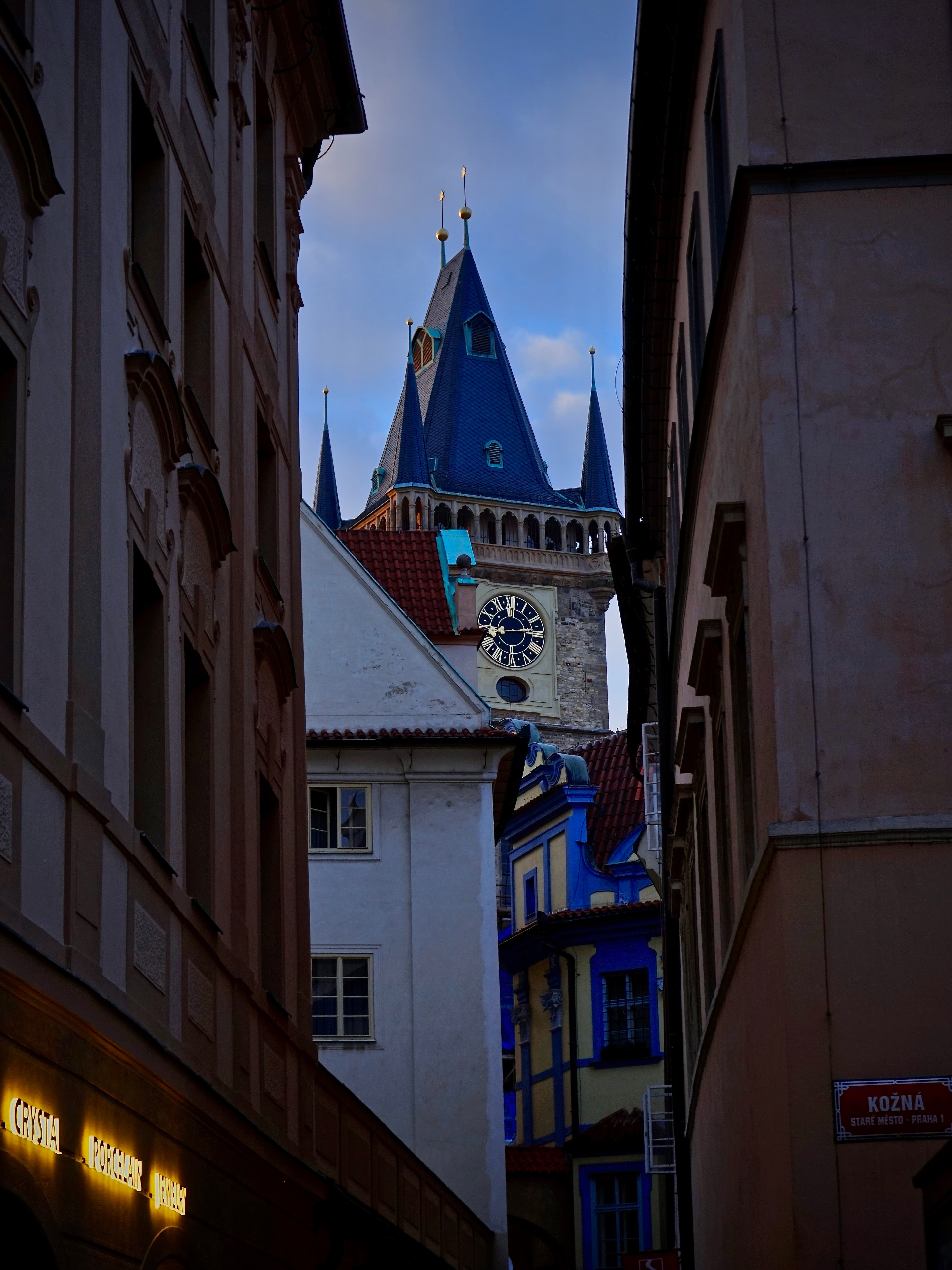 Narrow blue-hour clock tower and alley