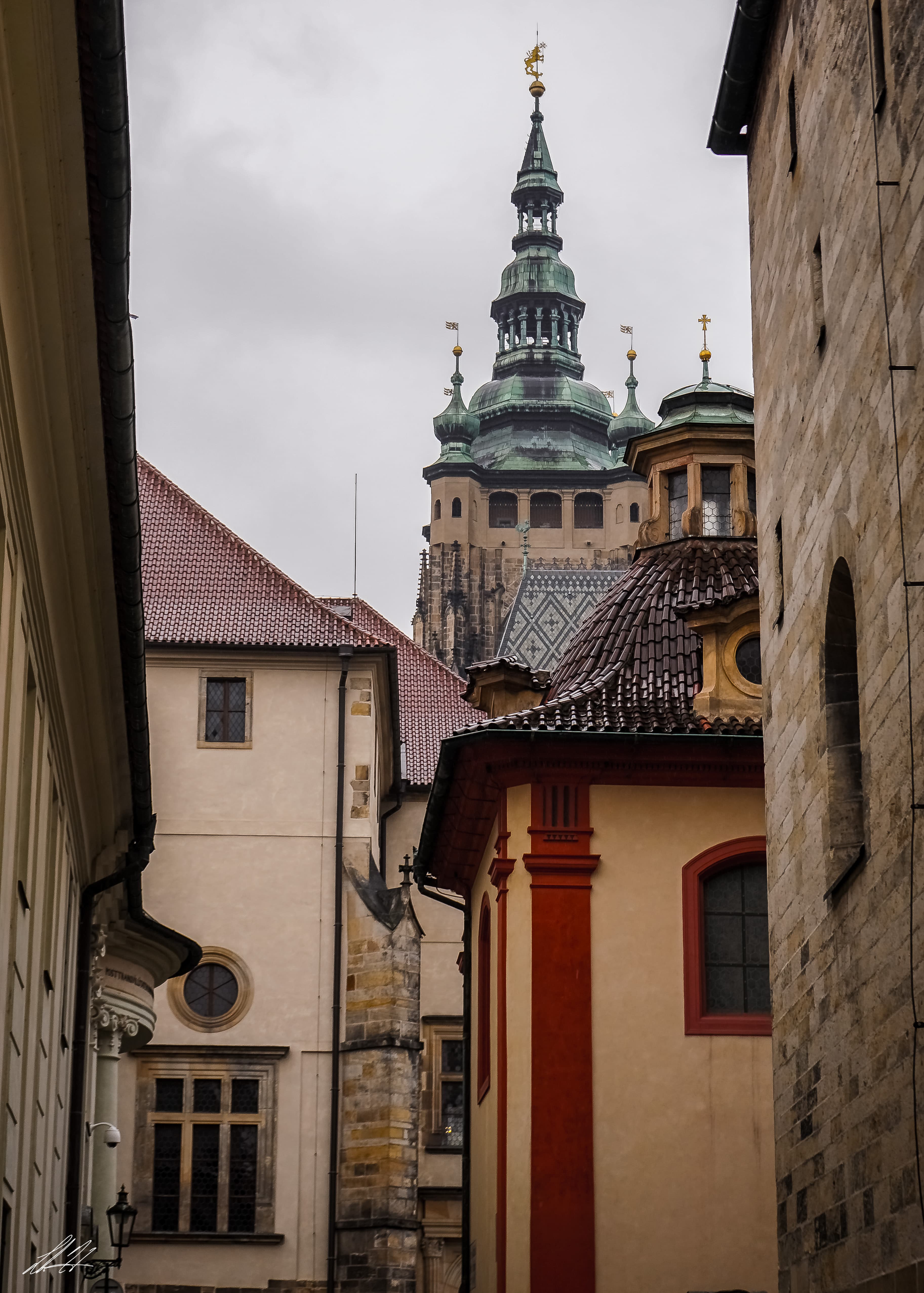 Looking between buildings toward a tower in Prague
