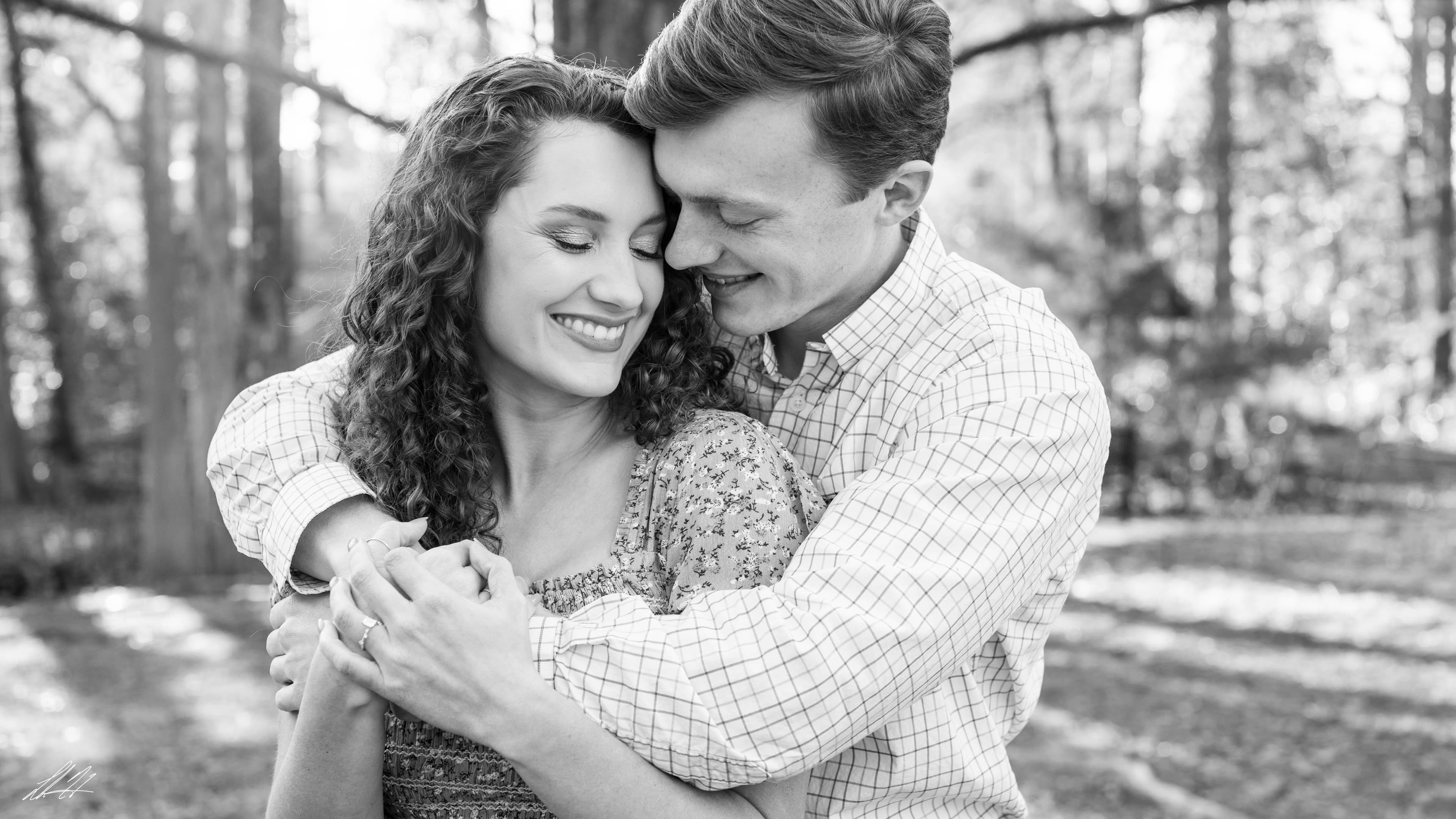 Black and white engagement portrait of a couple outdoors