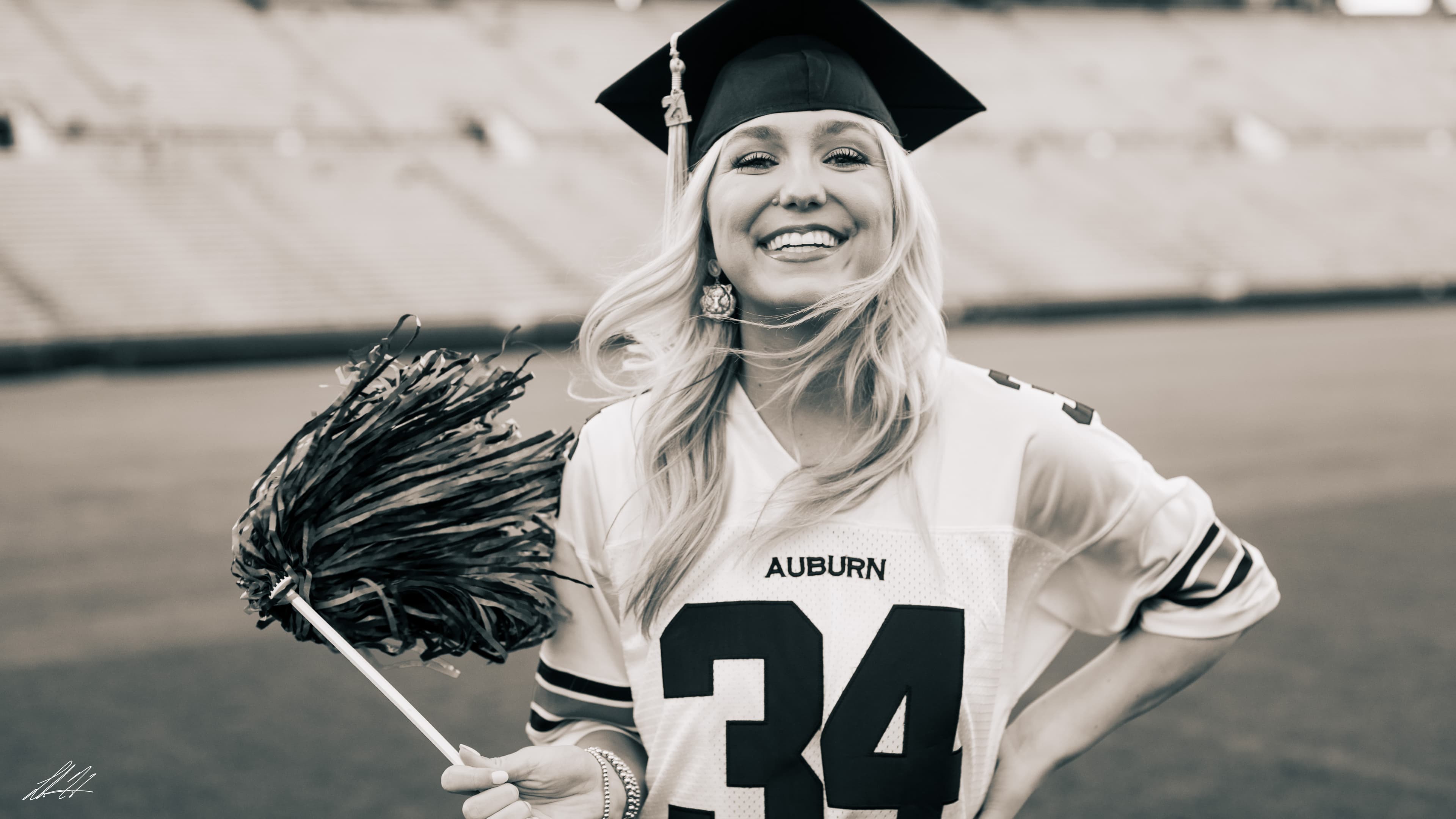 Black and white stadium portrait with pom-poms